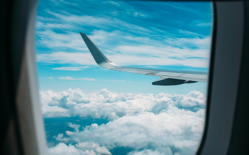 Airplane flying over clouds - can I travel with THC